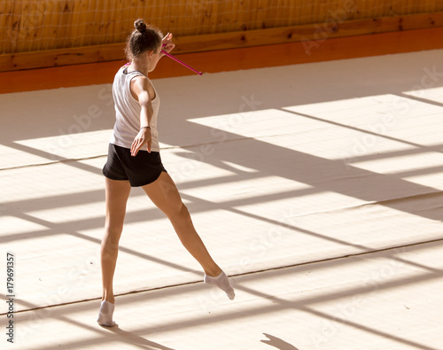 girl on a professional gymnast in the hall