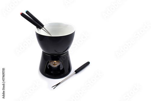 Fondue stock images. Fondue set on a white background. Black ceramic fondue set