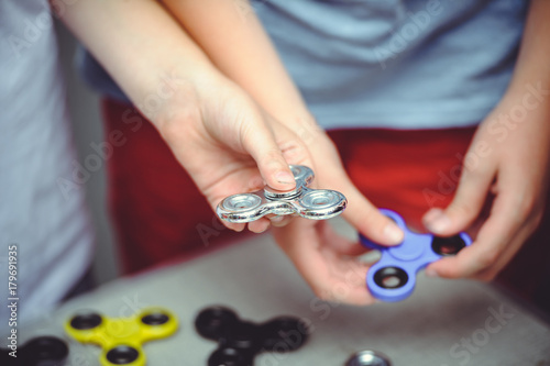 man holds a spiner in his hand rotates photo