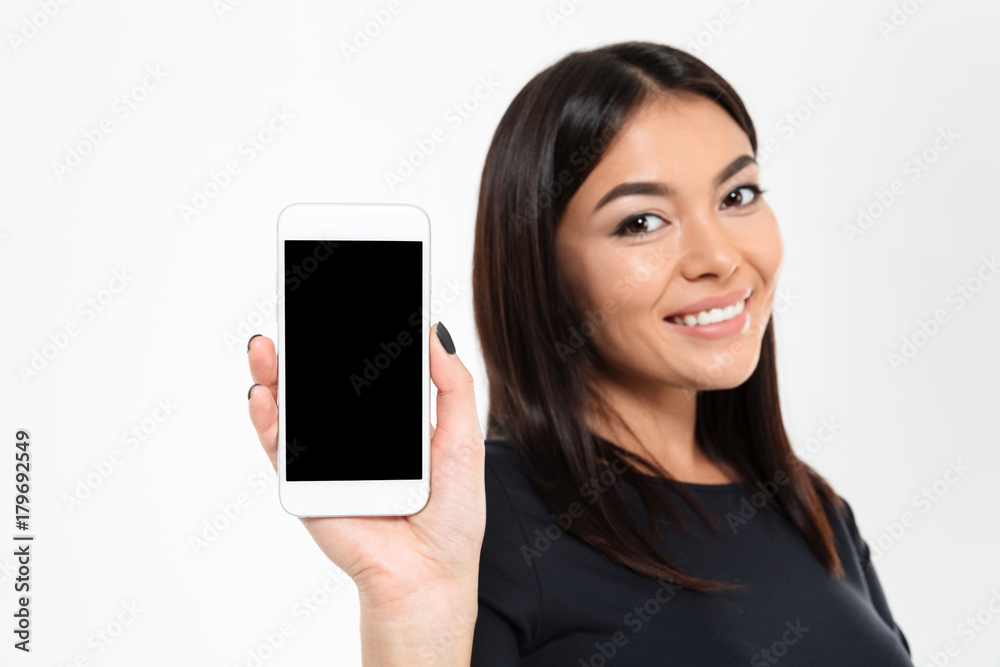 Cheerful young asian woman showing display of mobile phone Cheerful young asian woman showing display of mobile phone