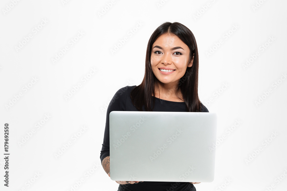 Happy young asian lady chatting by laptop computer Happy young asian lady chatting by laptop computer