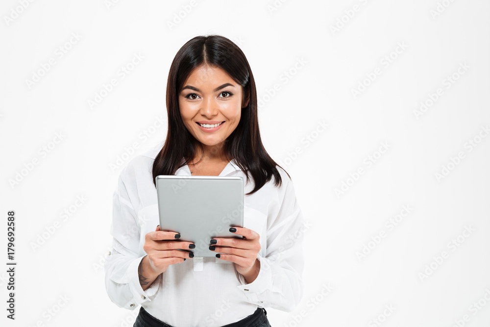 Happy young asian lady chatting by tablet computer Happy young asian lady chatting by tablet computer