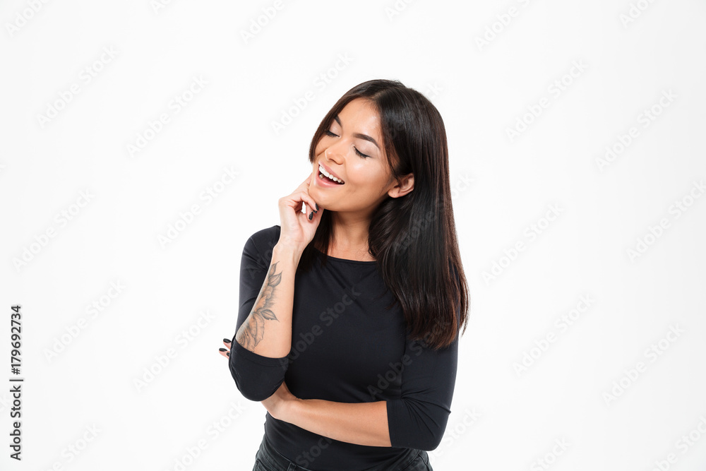 Laughing young asian lady standing isolated over white background Laughing young asian lady standing isolated over white background