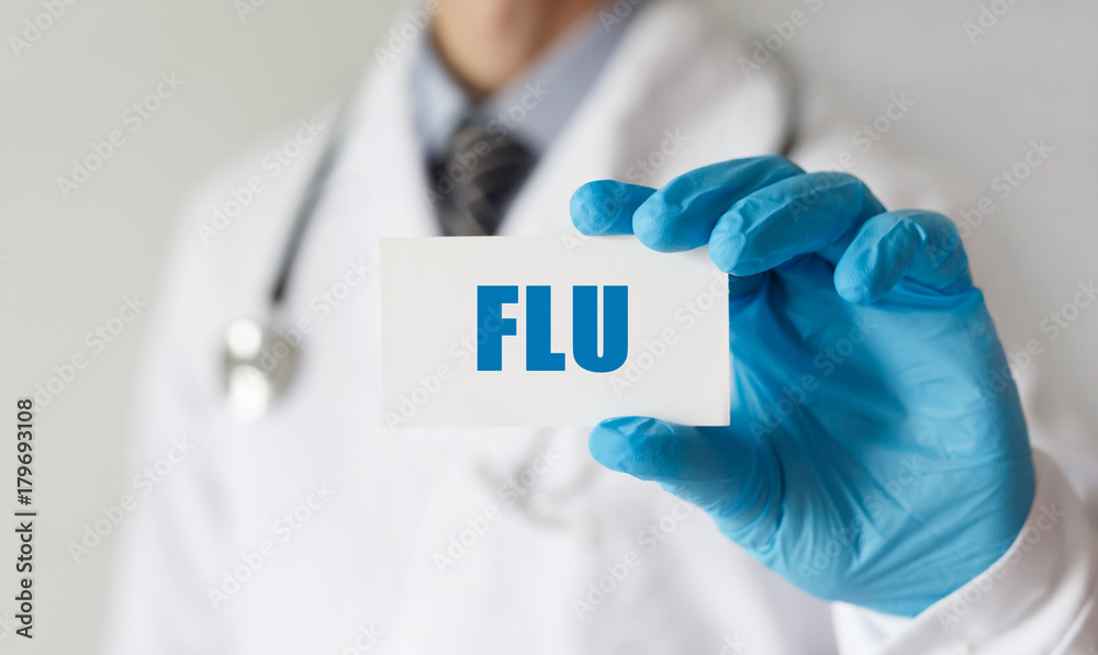 Doctor holding a card with text FLU , medical concept Doctor holding a card with text FLU , medical concept