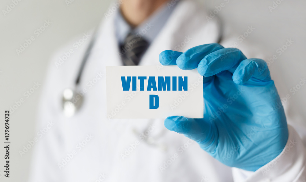 Doctor holding a card with text VITAMIN D,medical concept Doctor holding a card with text VITAMIN D,medical concept