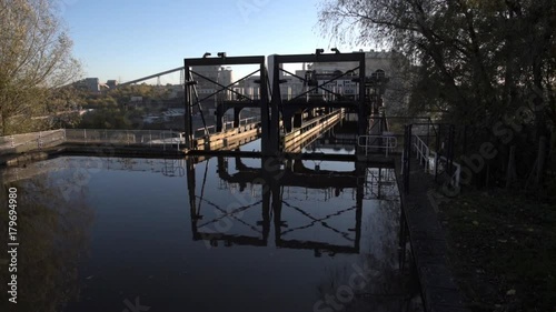 The famous Anderton boat lift that connects the River Weaver and the Trent and Mersey Canal with industrial plant in the background. photo