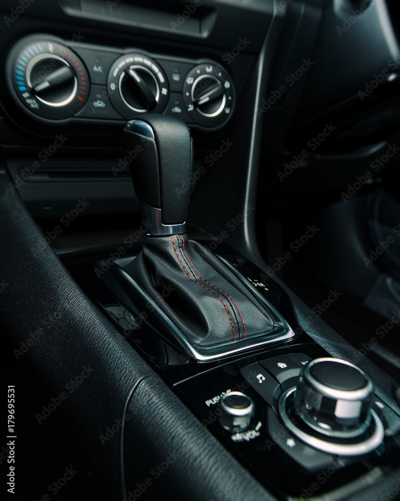 Car gear stick, handbrake, air conditioning and music controls