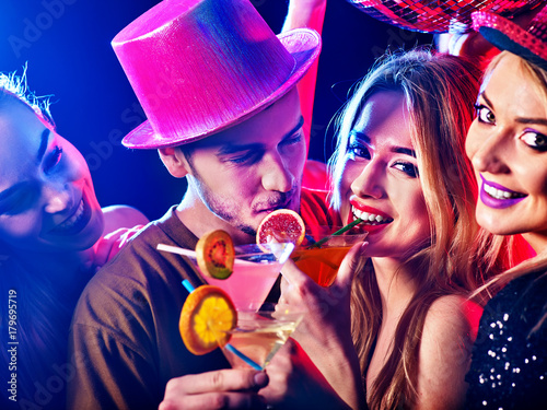 Cocktail party for couple in love disco dancing and drink . Happy women in evening dresses and men have fun in night club . Rest after hard day at work on loving date.