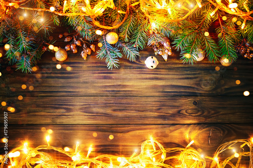 Christmas background, a table decorated with Christmas garland and fir branches With New Year and Christmas. © Anna