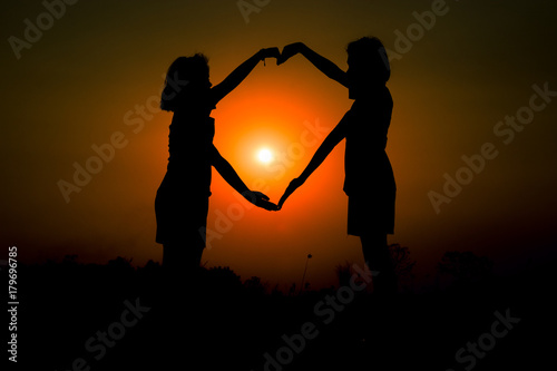 silhouette two girl on romantic scene