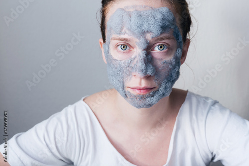 Beautiful young woman with hydrating bubble mask