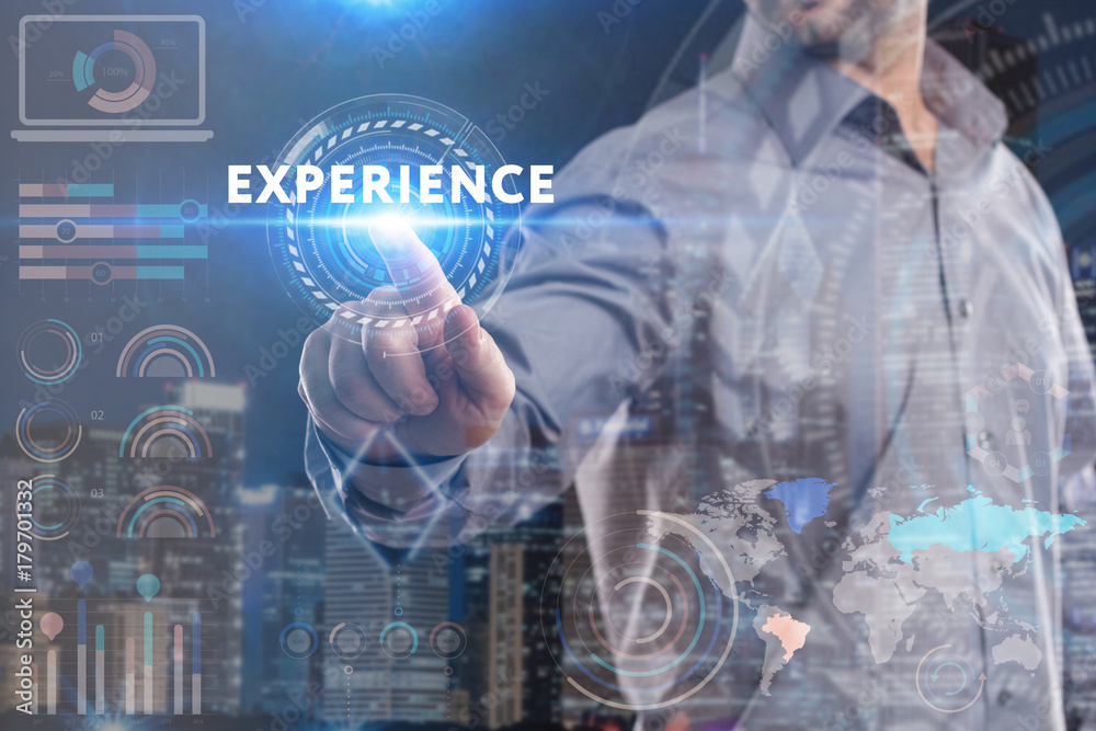 Business, Technology, Internet and network concept. Young businessman working on a virtual screen of the future and sees the inscription: Experience Business, Technology, Internet and network concept. Young businessman working on a virtual screen of the future and sees the inscription: Experience