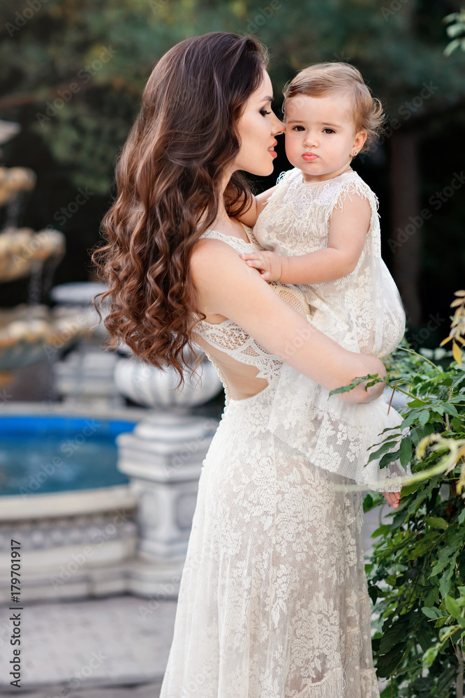Mom and child in amazing dresses outdoor