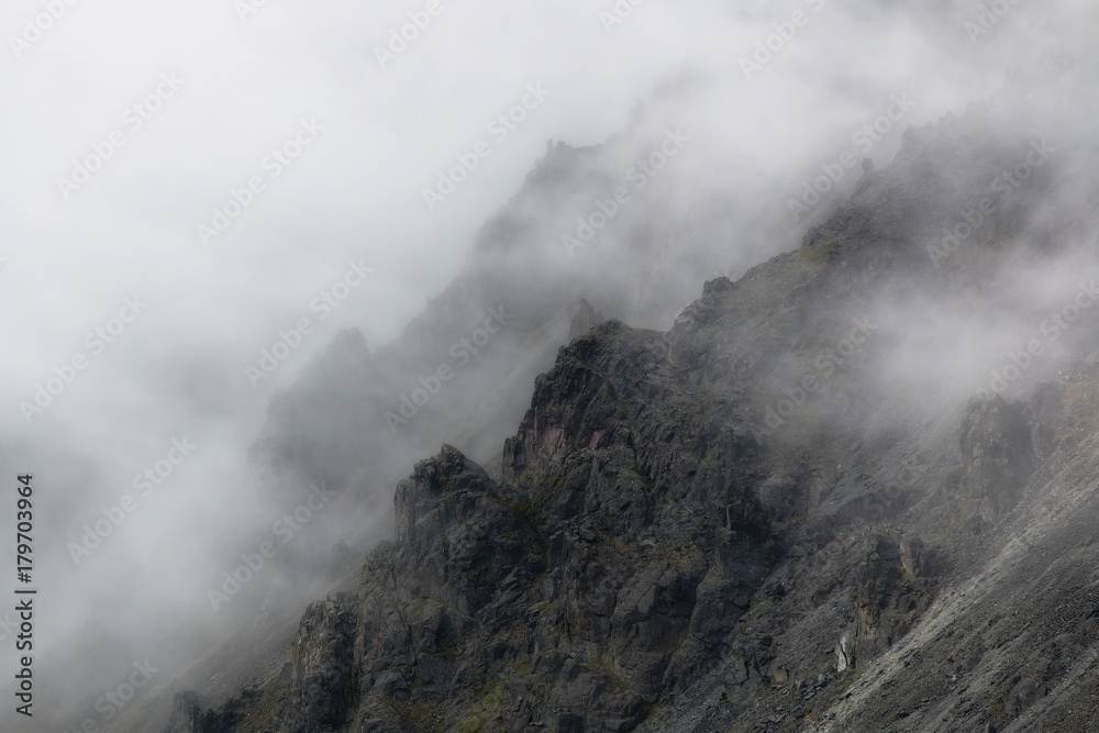 rugged mountain peaks in mist