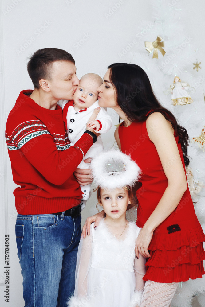 Happy family at home at Christmas with a Christmas tree Happy family at home at Christmas with a Christmas tree