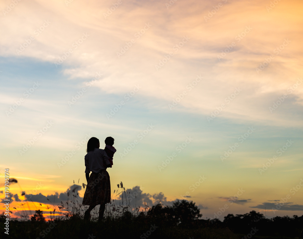 silhouette Happy mother and daughter laughing together outdoors