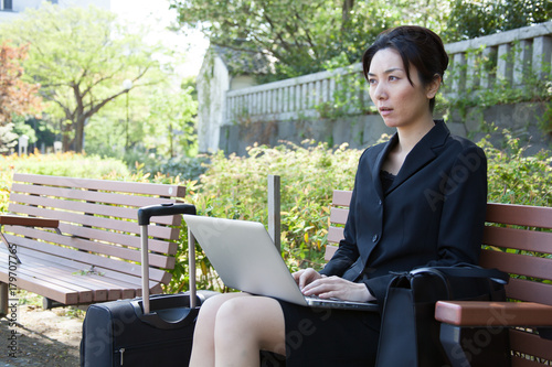 Japanese Business Woman Uses Laptop Outside