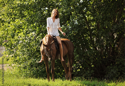 Young attractive woman relaxing horseback  © horsemen