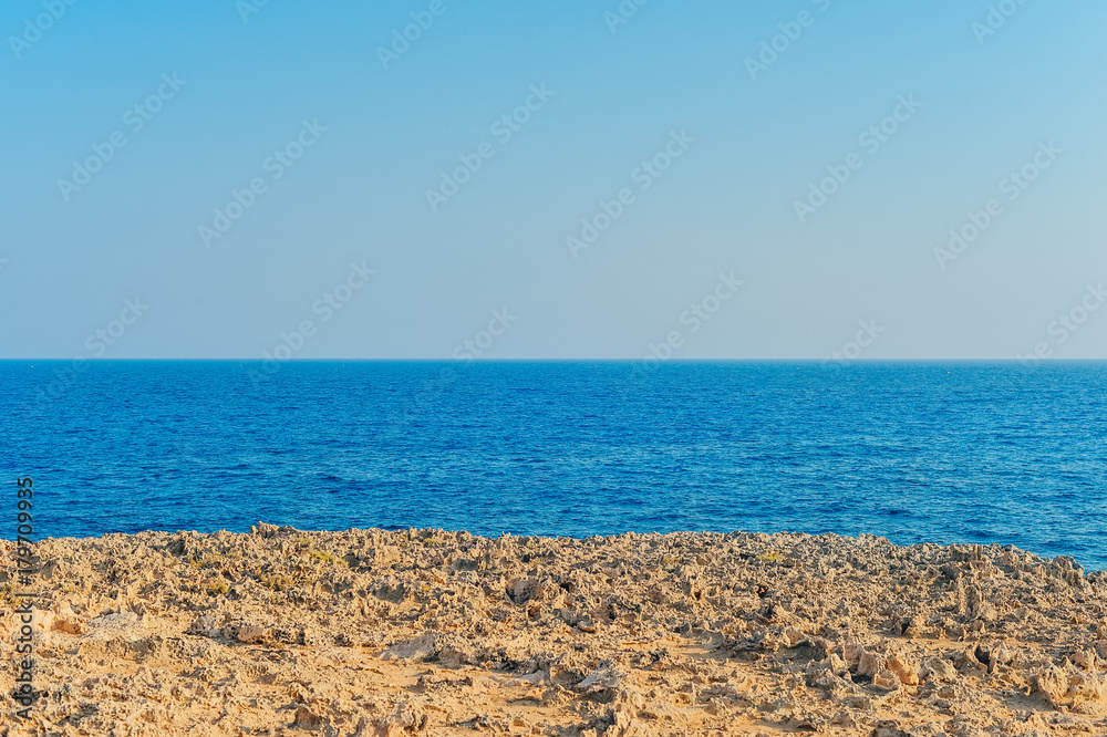 View of the blue sea. Dried earth