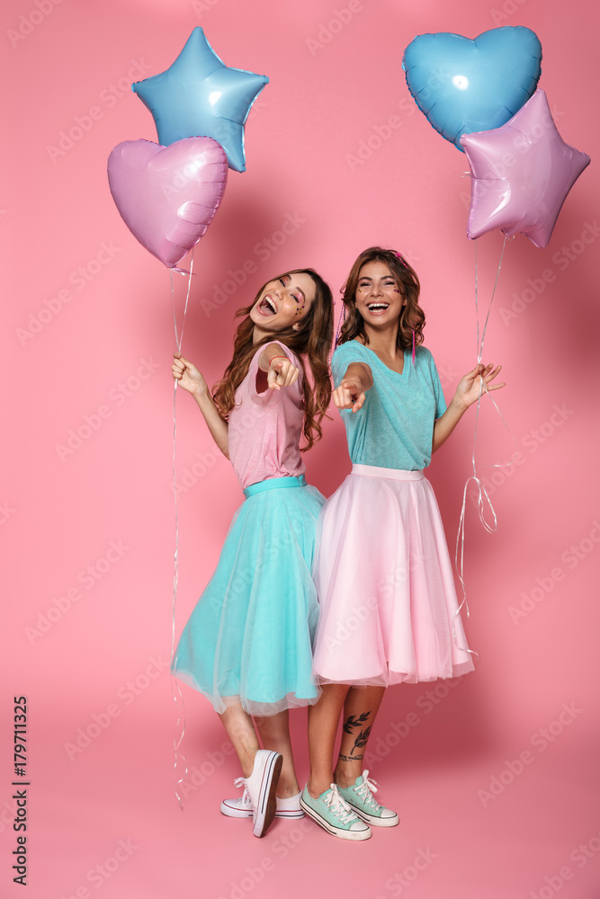 Two cheerful young girls - obrazy, fototapety, plakaty 
