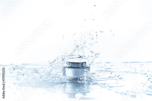Cream pot and water splash. Concept beauty and fresh..