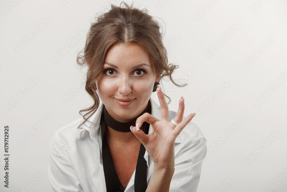 Young woman, beautiful hair, makeup, men's white shirt on a white background Young woman, beautiful hair, makeup, men's white shirt on a white background