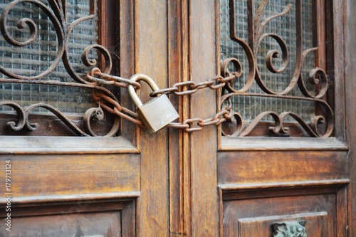 Old safety lock on rusty door