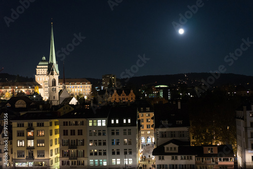 zurich city by night with full moon shinging and light on buildings