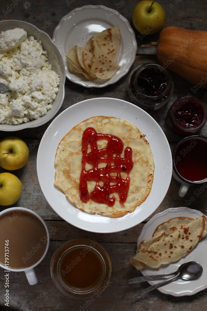 pancakes with jam on a wooden table pancakes with jam on a wooden table