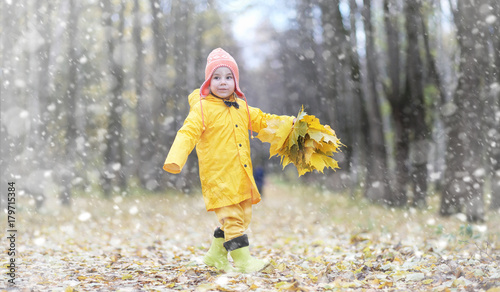 Toddlers on a walk in the autumn park. First frost and the first