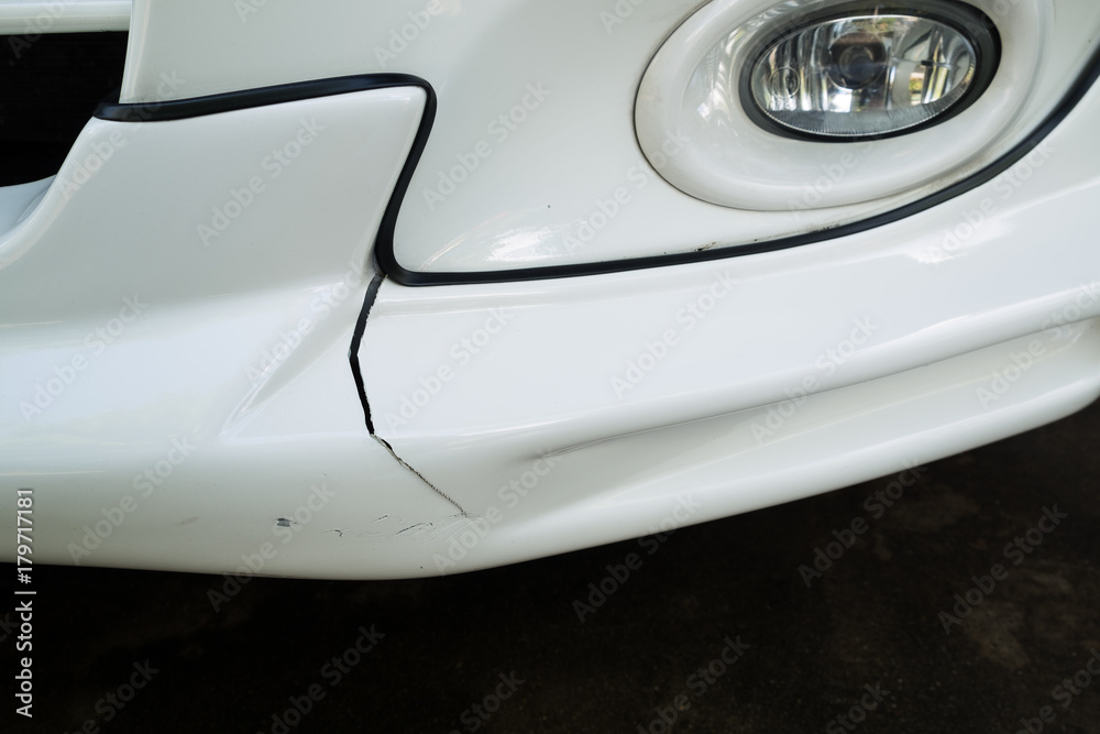 Front bumper of a car broken and damage from accident on the road