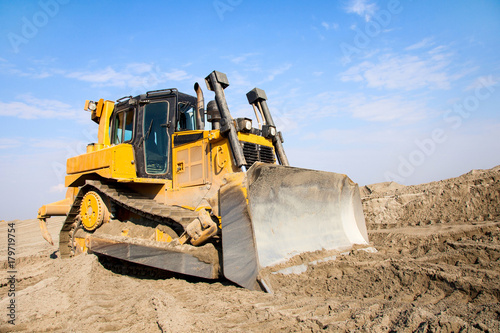 The bulldozer works on a sandy quarry. photo