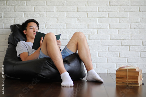 Asian student sitting on pillow and getting ready for exam