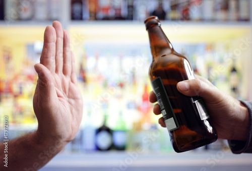 Quadro su tela Hand rejecting alcoholic beer beverage bottle