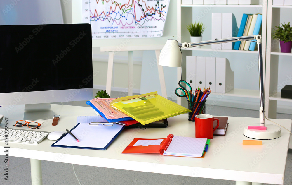 Office table with blank notepad and laptop Office table with blank notepad and laptop