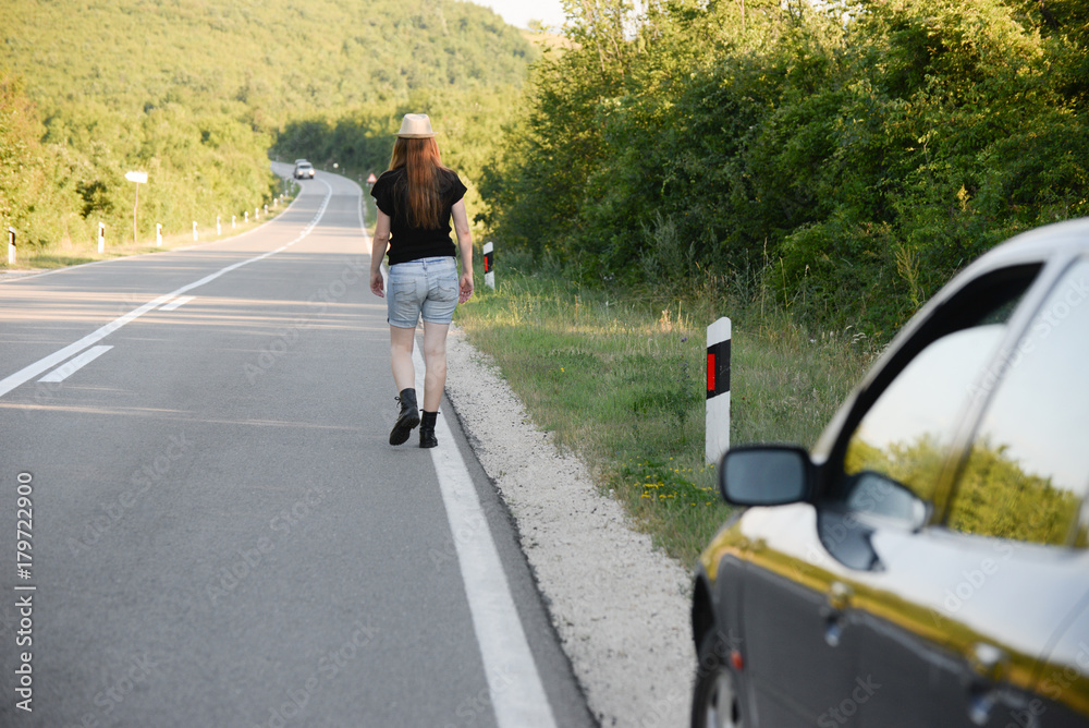 Concept of broken car. Lonely middle aged woman on the road with broken car Concept of broken car. Lonely middle aged woman on the road with broken car