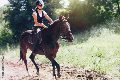 Picture of young pretty girl riding her horse