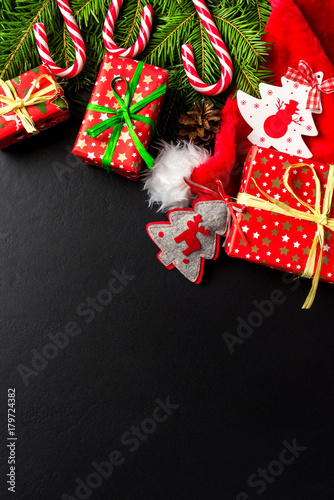 Christmas background with colorful gift boxes and Santa hat