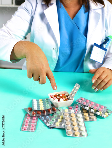 Female doctor hand hold pack of different tablet blisters at workplace. Panacea, life save service, prescribe medicament, legal drug store, disease healing, blood pressure concept. Letterbox view
