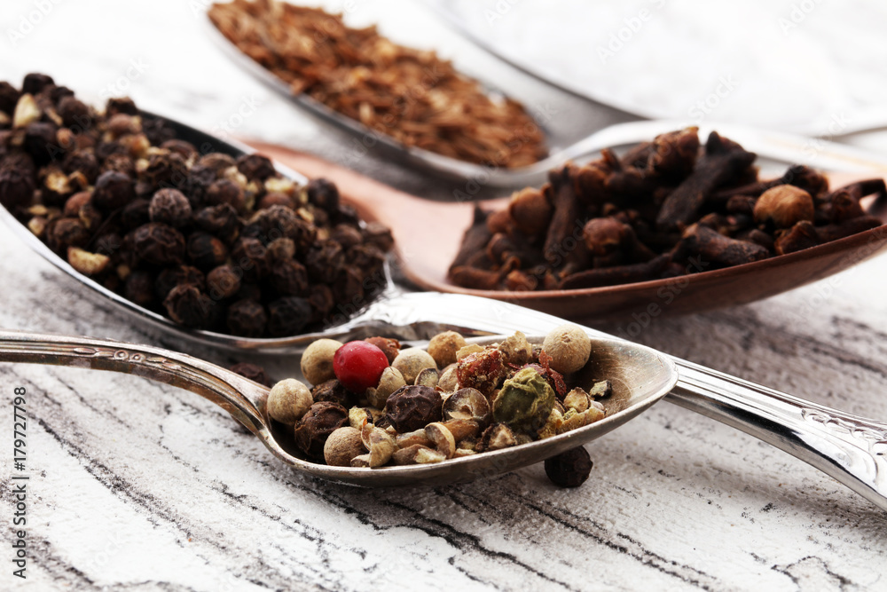 Various spices and spoons on white wooden table. Various spices and spoons on white wooden table.