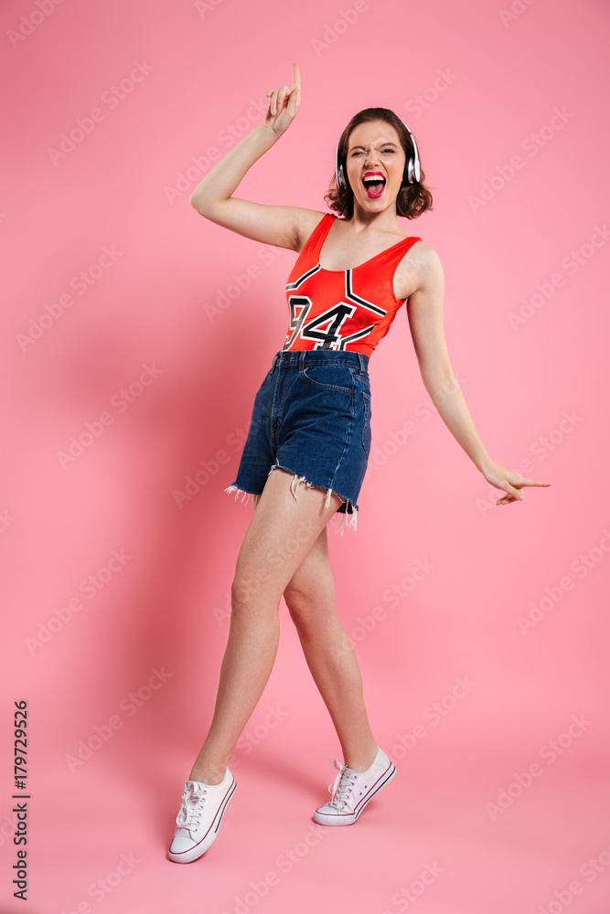 Excited amazing young lady dancing isolated Excited amazing young lady dancing isolated