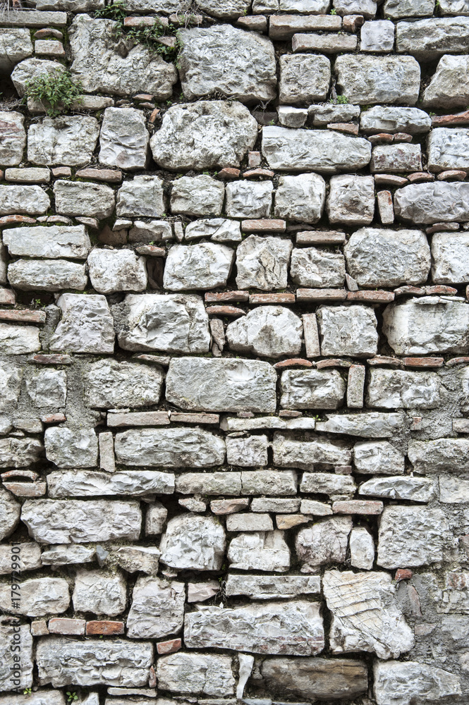 Gubbio, Perugia, Italy - ancient wall in a small typical street of the Gubbio village. Gubbio, Perugia, Italy - ancient wall in a small typical street of the Gubbio village.