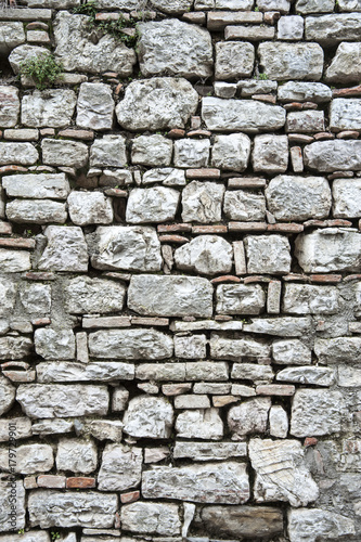 Gubbio, Perugia, Italy -   ancient wall in a small typical street of the Gubbio village.