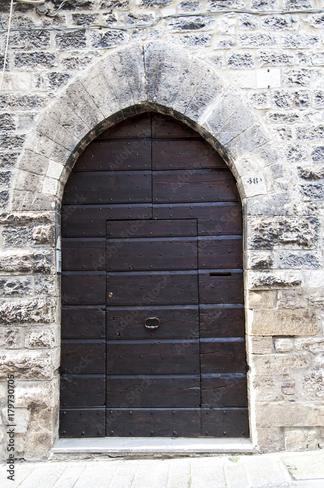 Gubbio, Perugia, Italy - entrance door, architectural details of the ancient palaces Gubbio, Perugia, Italy - entrance door, architectural details of the ancient palaces