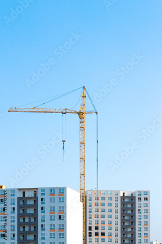 Construction crane and buildings against the sky