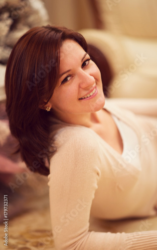 Portrait of pretty young woman looking with easy attractive smile