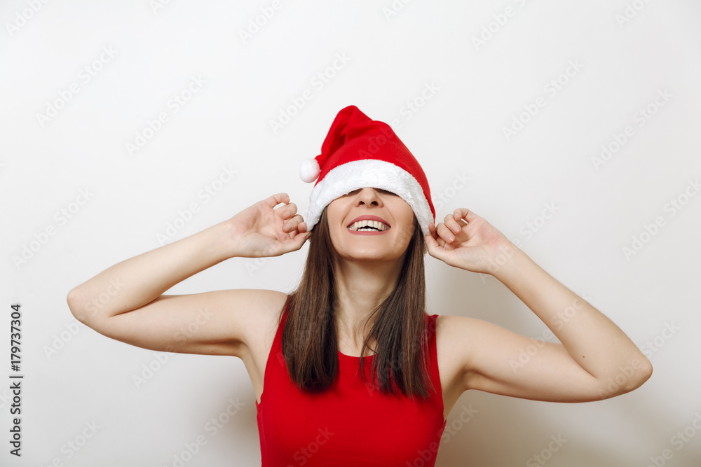Beautiful caucasian young happy woman with healthy skin and charming smile wearing red dress and Christmas hat on white background. Santa girl isolated portrait. New Year holiday 2018 concept Beautiful caucasian young happy woman with healthy skin and charming smile wearing red dress and Christmas hat on white background. Santa girl isolated portrait. New Year holiday 2018 concept