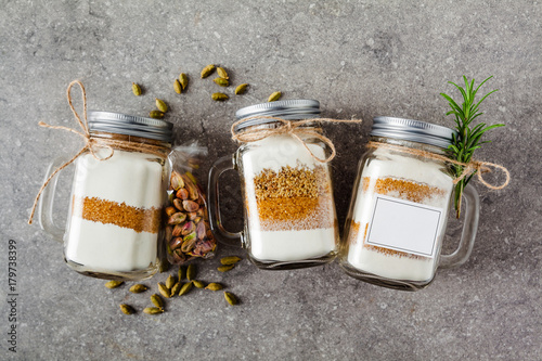 Photographie mix of flour, sugar, nuts for baking in a jar . Handmade gift.