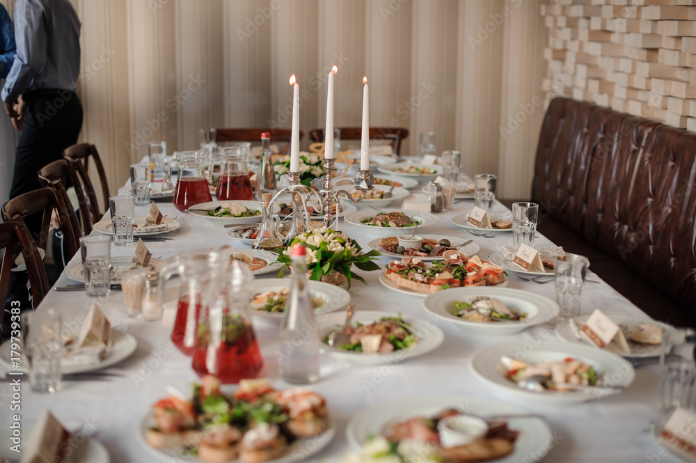 Table served and decorated for a celebration dinner Table served and decorated for a celebration dinner