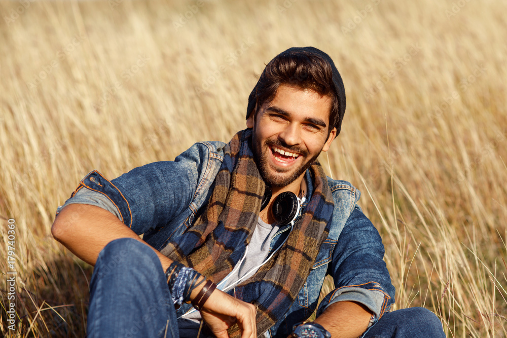 Portrait of a smiling young man in a meadow Portrait of a smiling young man in a meadow